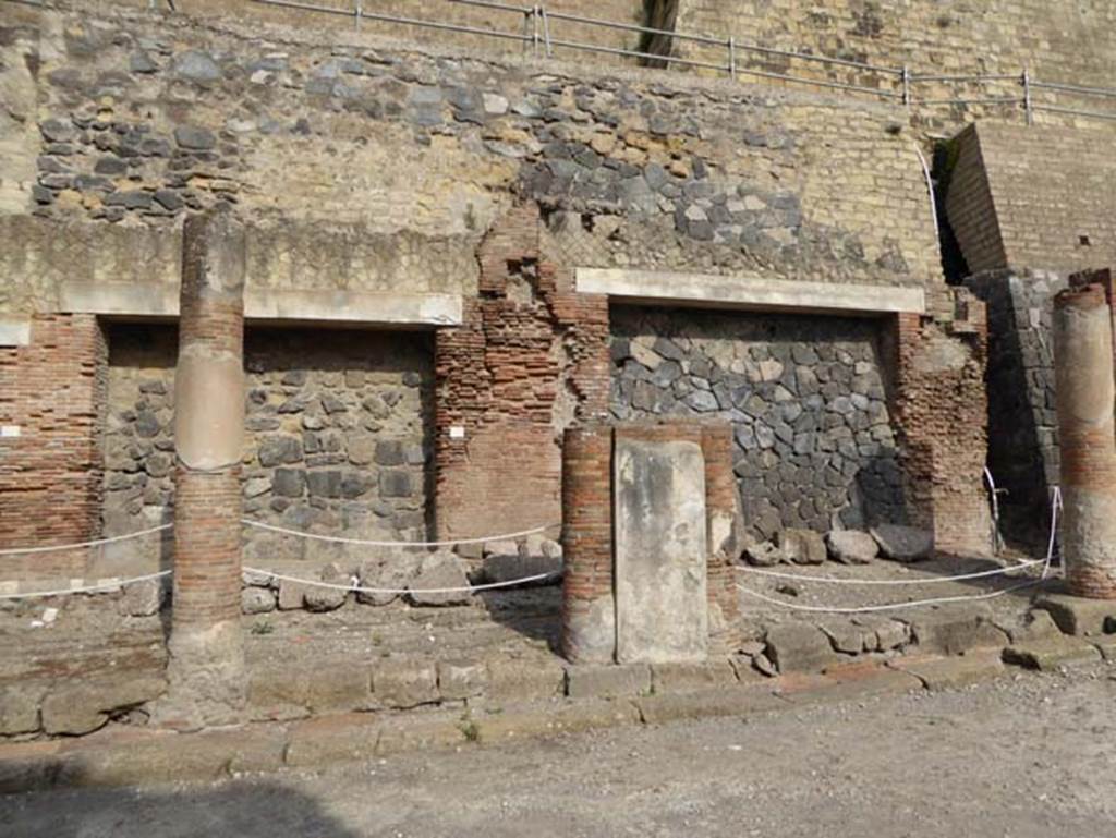 Decumanus Maximus, Herculaneum, October 2014. Building on north side of the Decumanus Maximus, doorway numbered 10, on left, and number 11, on right.
Photo courtesy of Michael Binns.
